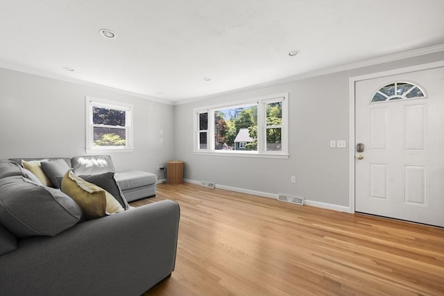 56 Country Way, Whitman, MA 02382 - living area with crown molding, healthy amount of natural light, light wood-style floors, baseboards, and recessed lighting