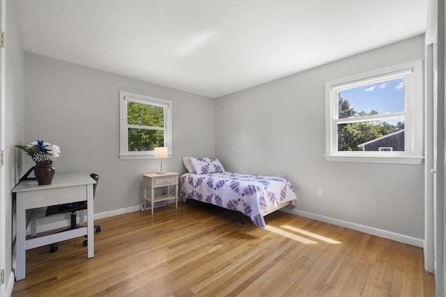 56 Country Way, Whitman, MA 02382 - bedroom featuring multiple windows, baseboards, and light wood finished floors