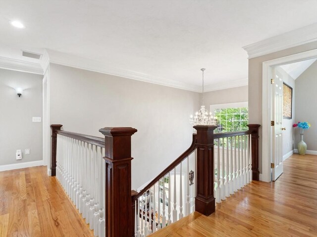 231 Gulf St, Shrewsbury, MA 01545 - corridor featuring an upstairs landing, a chandelier, light wood-type flooring, baseboards, and crown molding