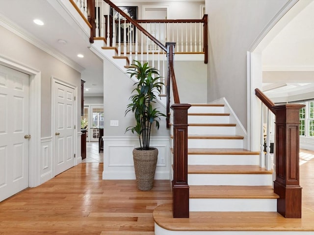 231 Gulf St, Shrewsbury, MA 01545 - staircase with wood finished floors, ornamental molding, recessed lighting, and a wainscoted wall