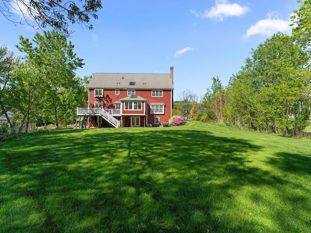 231 Gulf St, Shrewsbury, MA 01545 - back of property featuring stairs, a chimney, a wooden deck, and a lawn