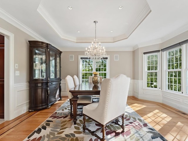 231 Gulf St, Shrewsbury, MA 01545 - dining area featuring a chandelier, a tray ceiling, light wood finished floors, wainscoting, and a decorative wall