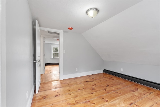 bonus room with light hardwood / wood-style flooring and lofted ceiling