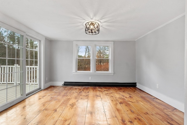 unfurnished dining area with a notable chandelier, crown molding, light wood-type flooring, and plenty of natural light