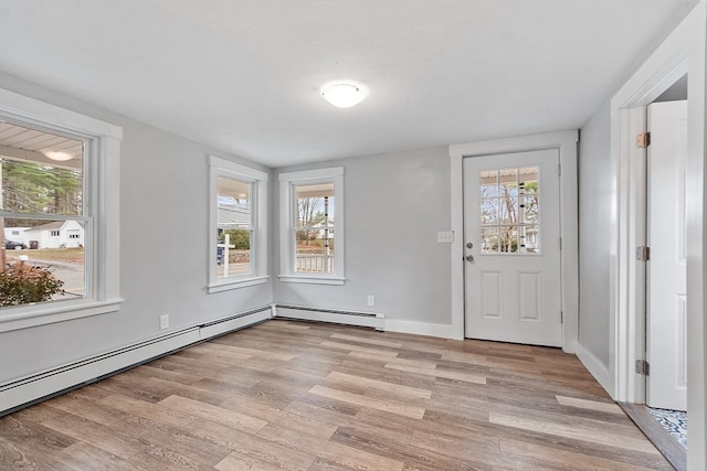 entrance foyer with a baseboard heating unit and light wood-type flooring