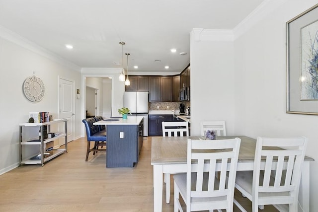 dining area with recessed lighting, baseboards, ornamental molding, and light wood-type flooring