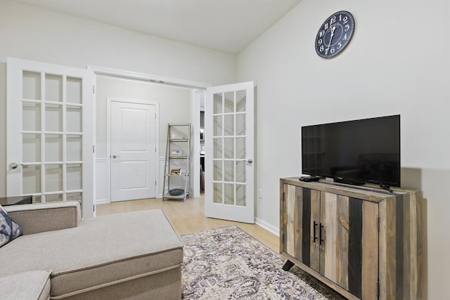 living area featuring light wood-type flooring and french doors