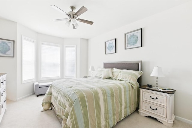 bedroom with baseboards, light carpet, and ceiling fan