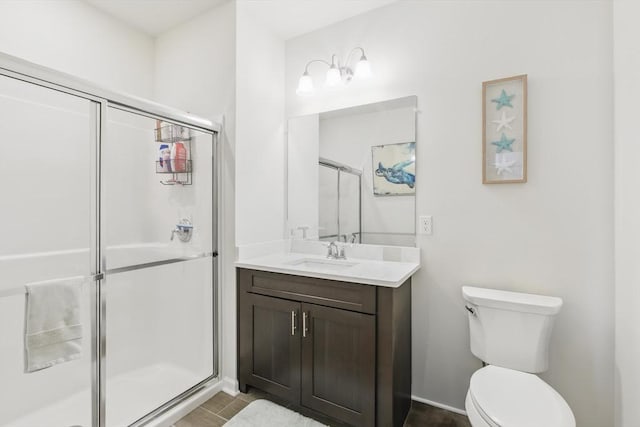 bathroom with vanity, toilet, tile patterned flooring, and a stall shower