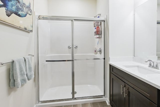 bathroom featuring vanity and a shower stall