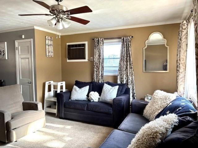 living room featuring crown molding, carpet flooring, a wall mounted air conditioner, and ceiling fan