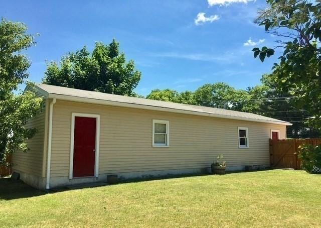 back of property with a lawn