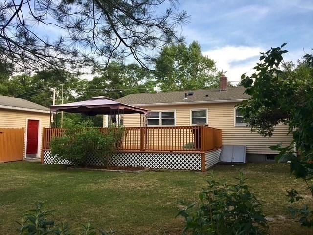 back of house with a lawn, a gazebo, and a deck