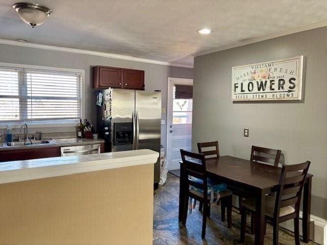 kitchen with sink, appliances with stainless steel finishes, and ornamental molding