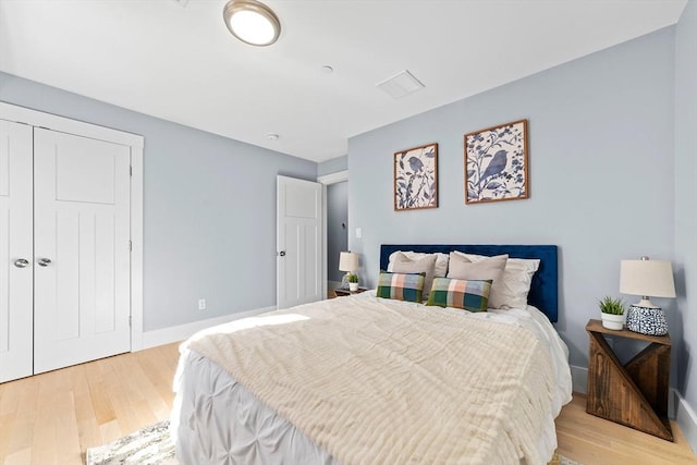 bedroom featuring baseboards and light wood-style floors