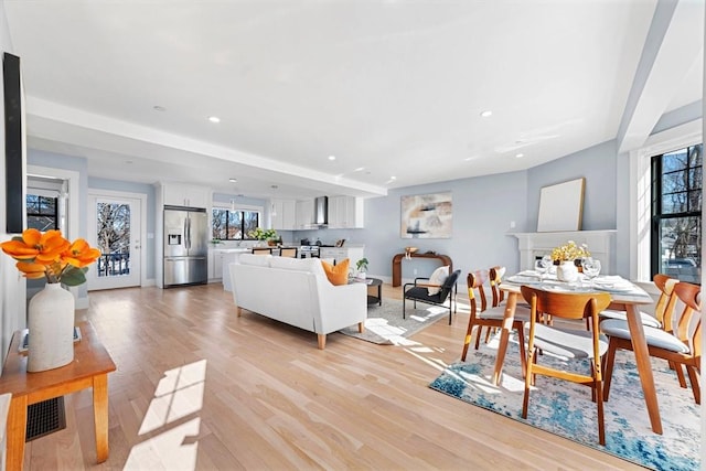 living area with recessed lighting, baseboards, and light wood finished floors