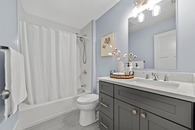 bathroom with shower / tub combo with curtain, vanity, and toilet