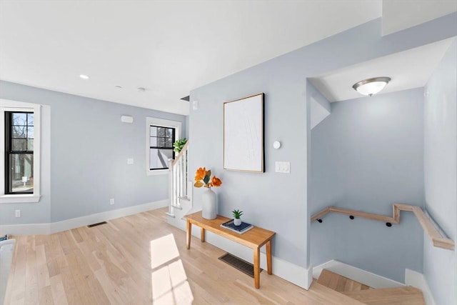 interior space featuring visible vents, baseboards, and wood finished floors