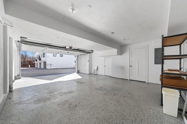 garage featuring a garage door opener and electric panel