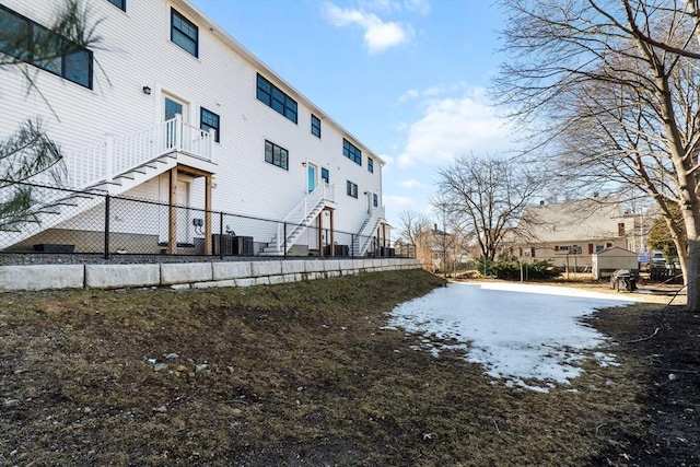 view of yard featuring cooling unit and fence