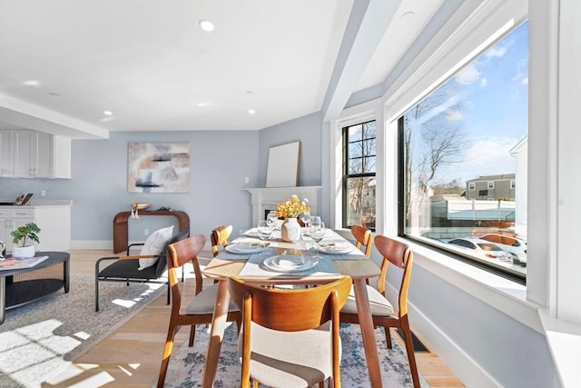 dining room with light wood-style floors, baseboards, and recessed lighting