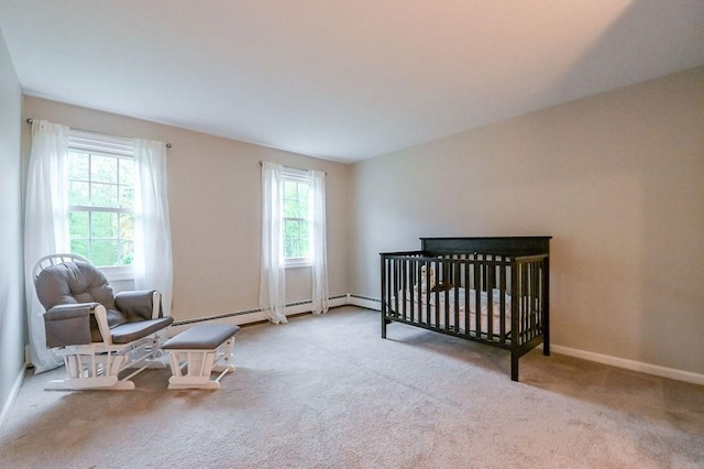bedroom with carpet flooring, a crib, and baseboards