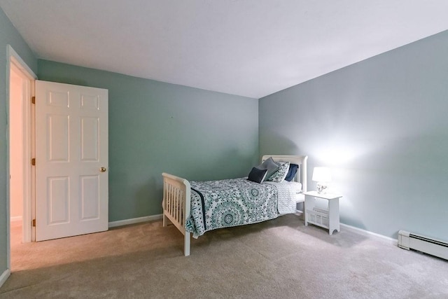 bedroom featuring a baseboard heating unit, carpet flooring, and baseboards