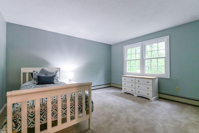 bedroom featuring a baseboard heating unit, carpet flooring, and baseboards