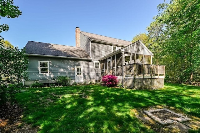 rear view of house featuring a sunroom, a chimney, and a yard