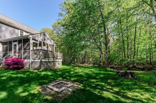 view of grassy yard with a sunroom