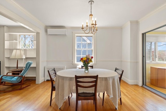 dining area featuring a healthy amount of sunlight, light wood finished floors, a wall mounted air conditioner, and a chandelier