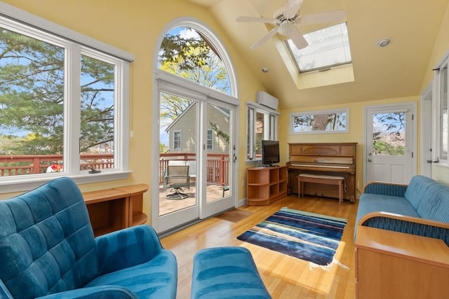 sunroom / solarium featuring a wall unit AC, a wealth of natural light, and a skylight