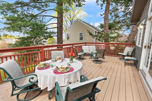 wooden terrace with outdoor dining area