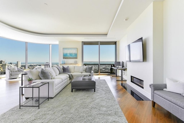 1 Dalton St Unit 5102, Boston, MA 02115 - living area featuring expansive windows, plenty of natural light, a glass covered fireplace, and wood finished floors