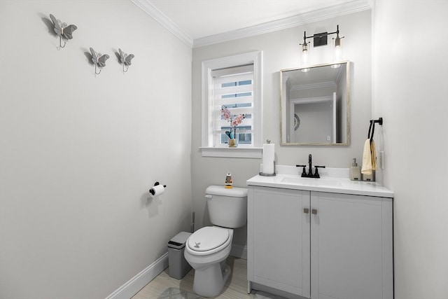 half bath with vanity, toilet, crown molding, and baseboards