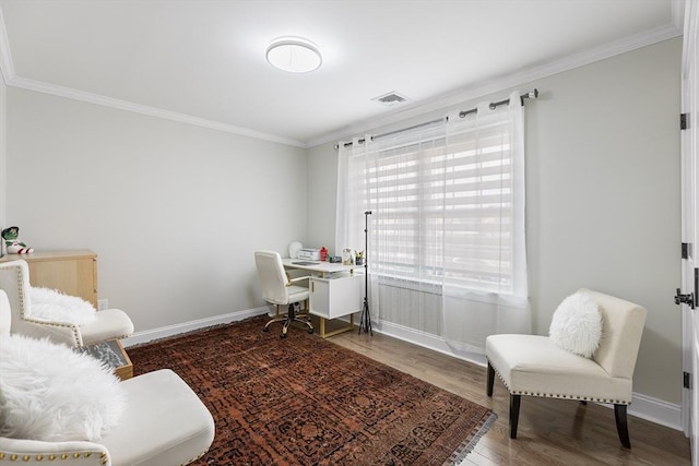 home office featuring crown molding, wood finished floors, visible vents, and baseboards