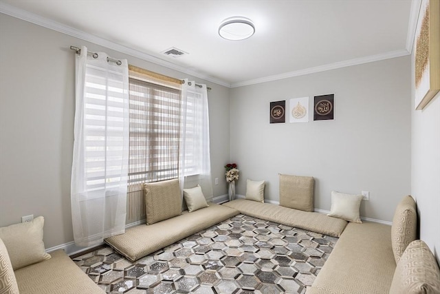 sitting room featuring visible vents, carpet floors, baseboards, and ornamental molding