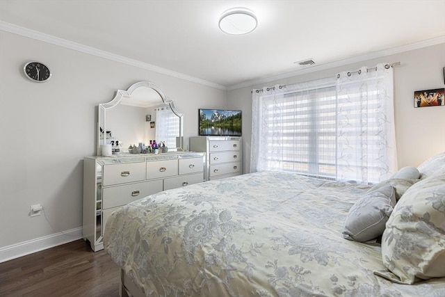 bedroom with dark wood-style floors, crown molding, and baseboards