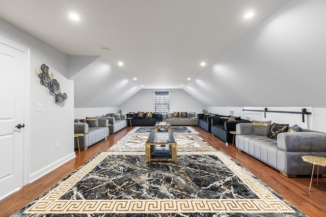 living room with recessed lighting, wood finished floors, and vaulted ceiling