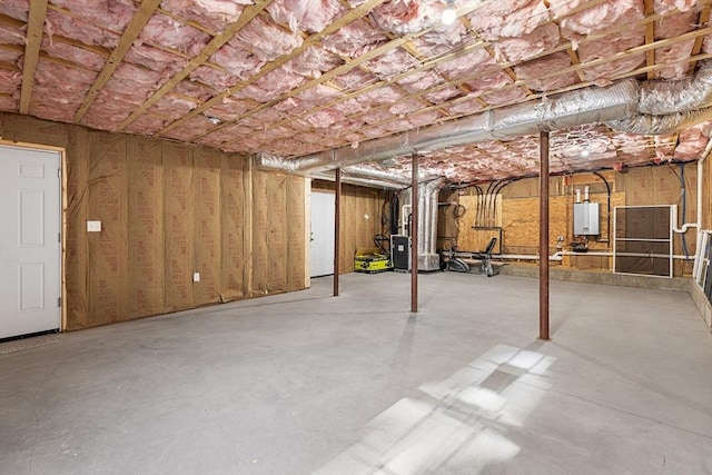 unfinished basement with water heater and heating unit