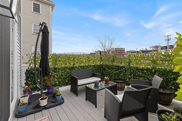 wooden terrace with an outdoor hangout area