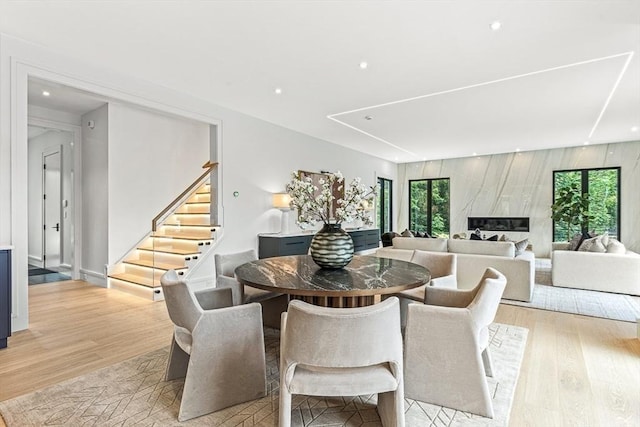 dining room with stairs, light wood-type flooring, and recessed lighting