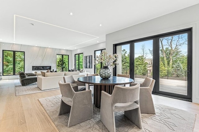 dining area with light wood-style flooring and recessed lighting