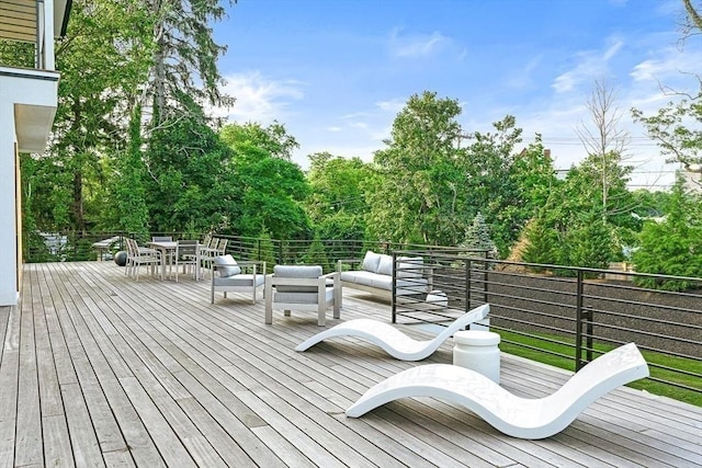 wooden deck featuring outdoor dining area and an outdoor living space