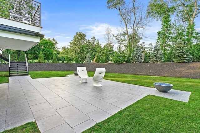 view of patio / terrace with stairway and fence