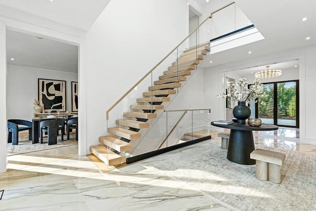 stairway featuring recessed lighting, marble finish floor, and an inviting chandelier