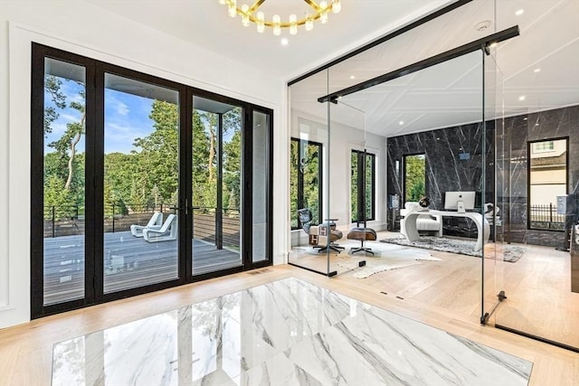 entryway featuring french doors and a notable chandelier