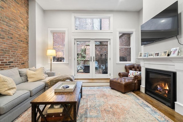 living room featuring french doors, a high ceiling, and hardwood / wood-style floors