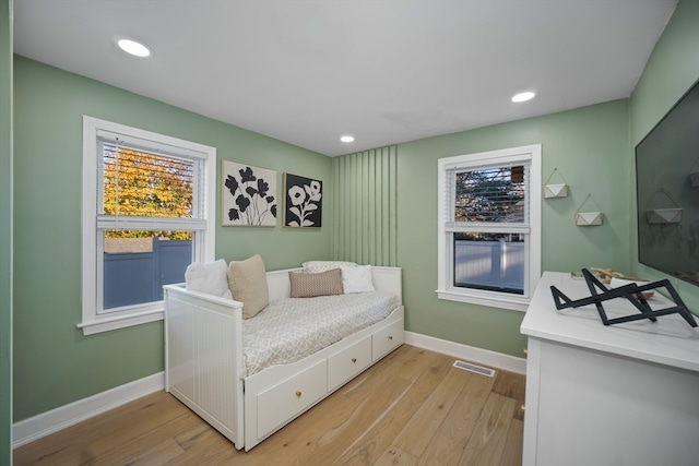 living area with a healthy amount of sunlight and light hardwood / wood-style floors