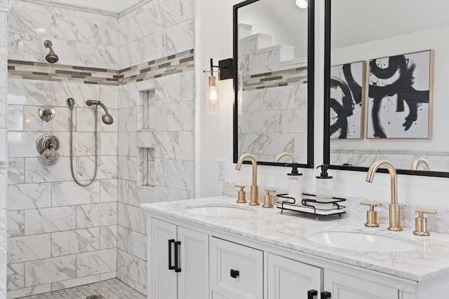 bathroom with tiled shower and vanity